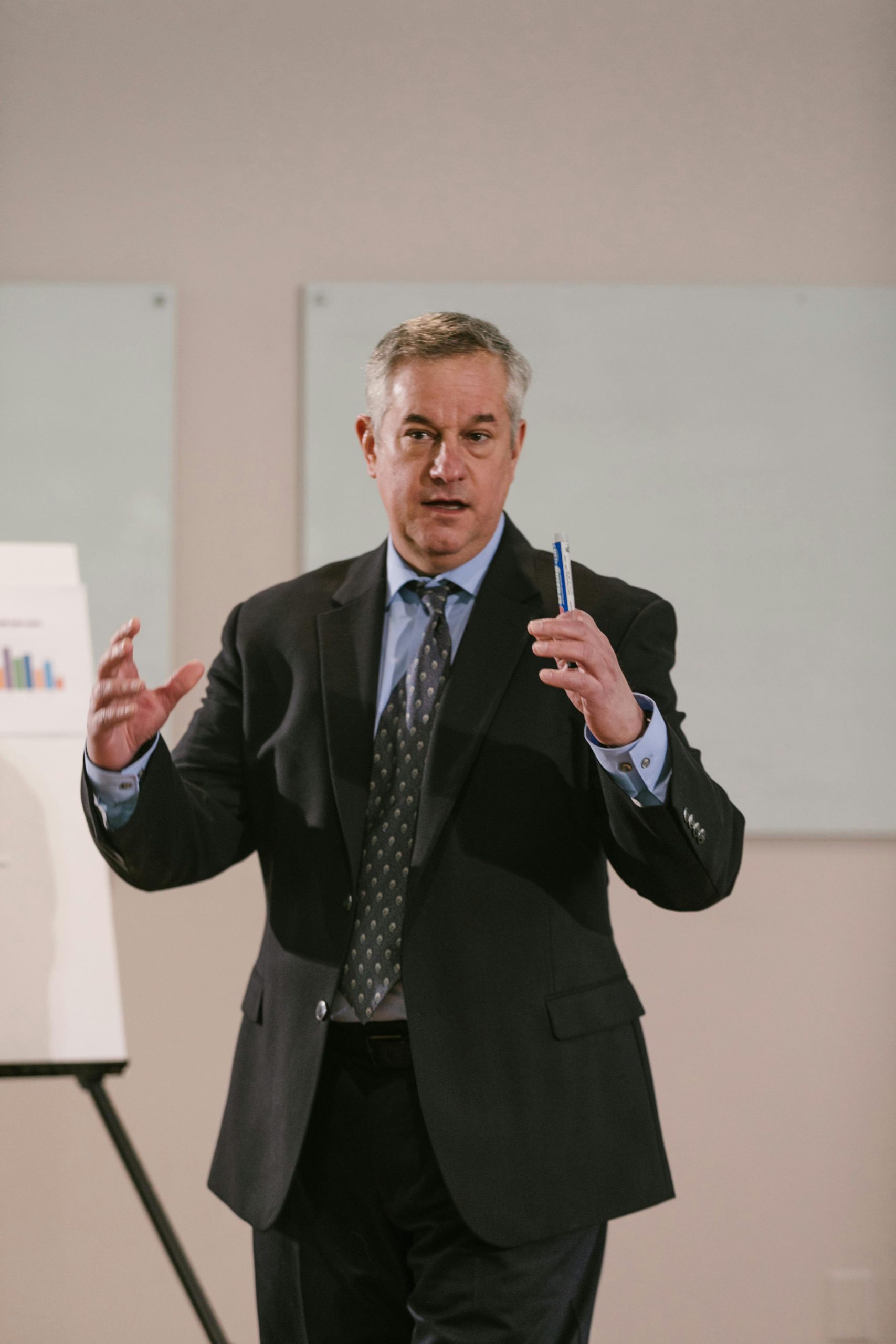 Man in suit standing and as if training people